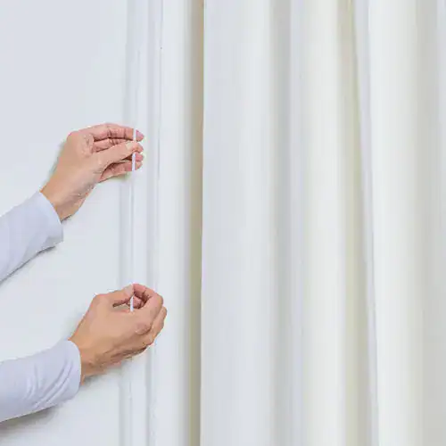 Seamless white outdoor shade curtain installation for patio privacy and sun protection.