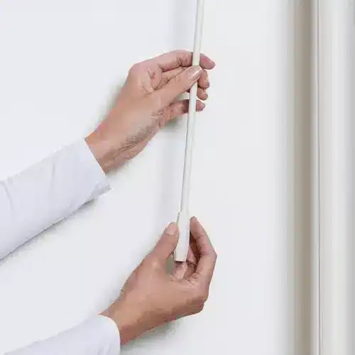 Close-up of a person connecting electrical wiring, showcasing home wiring process, electrical safety, professional electrician work, modern electrical setup.